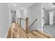 Bright hallway with wood floors, white trim, and natural light flowing through the landing at 5504 Earle Road, Raleigh, NC 27606