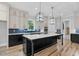 Modern kitchen showcasing a large island, custom cabinets, and stylish pendant lights at 5504 Earle Road, Raleigh, NC 27606
