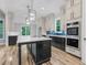 Spacious kitchen with a large island, stainless steel appliances, hardwood floors, and custom cabinetry at 5504 Earle Road, Raleigh, NC 27606