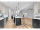 Open-concept kitchen with a large island, pendant lights, and seamless flow into the living area at 5504 Earle Road, Raleigh, NC 27606