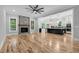 Bright living room with hardwood floors, a stone fireplace, and open access to the kitchen at 5504 Earle Road, Raleigh, NC 27606