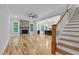 Open-concept living room with a fireplace, hardwood floors, and access to the modern kitchen at 5504 Earle Road, Raleigh, NC 27606