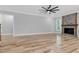 Spacious living room featuring wood floors, a stone fireplace, and recessed lighting at 5504 Earle Road, Raleigh, NC 27606