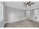 Large main bedroom features a tray ceiling, carpet, and doorway leading to en-suite bathroom and closet space at 5504 Earle Road, Raleigh, NC 27606