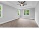 Spacious primary bedroom with neutral carpet, tray ceiling, and large windows providing ample natural light at 5504 Earle Road, Raleigh, NC 27606