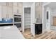 Pantry with white shelves, cabinet doors, and custom shelving system for efficient storage at 5504 Earle Road, Raleigh, NC 27606