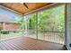 Covered porch with wood flooring, wood ceilings, white railings, and screened windows at 5504 Earle Road, Raleigh, NC 27606