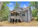 View of the home's rear, highlighting a covered porch and access to the backyard at 5504 Earle Road, Raleigh, NC 27606