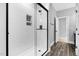 Modern bathroom with glass shower featuring subway tile and black trim at 5504 Earle Road, Raleigh, NC 27606