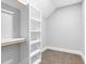 A neutral walk-in closet with carpet flooring and custom white shelving at 5504 Earle Road, Raleigh, NC 27606
