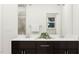 Bathroom vanity with double sinks, dark wood cabinets, and stylish fixtures at 5545 Cayden Cove Dr, Wendell, NC 27591