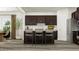 Kitchen island with bar stools, dark cabinetry, stainless steel appliances at 5545 Cayden Cove Dr, Wendell, NC 27591