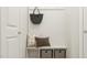 Mudroom with built-in bench, storage baskets, decorative pillows, and hooks at 5545 Cayden Cove Dr, Wendell, NC 27591
