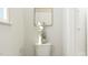 Bright powder room with a plant and art hanging above the toilet at 5545 Cayden Cove Dr, Wendell, NC 27591