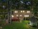 A backyard featuring a deck, a gazebo and mature trees surround the brick house at 5617 Partridge Ln, Raleigh, NC 27609