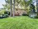 Spacious backyard featuring a well-maintained lawn, a deck, and a gazebo at 5617 Partridge Ln, Raleigh, NC 27609
