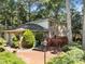 Spacious backyard with brick patio, wooden deck, and large trees at 5617 Partridge Ln, Raleigh, NC 27609