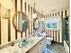 Bathroom with double sinks, marble countertops, and vintage lighting at 5617 Partridge Ln, Raleigh, NC 27609