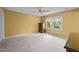 Comfortable bedroom with carpet, ceiling fan, and a bright window with view at 5617 Partridge Ln, Raleigh, NC 27609