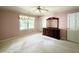 Bedroom with pink walls, ceiling fan, carpet floors, a large window, and dresser with a mirror at 5617 Partridge Ln, Raleigh, NC 27609