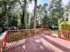 Spacious wooden deck overlooking a serene backyard with mature trees at 5617 Partridge Ln, Raleigh, NC 27609