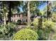 Traditional brick home featuring classic shutters and surrounded by lush greenery at 5617 Partridge Ln, Raleigh, NC 27609