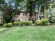 Beautiful two-story brick house with black shutters, green lawn, and mature landscaping at 5617 Partridge Ln, Raleigh, NC 27609