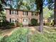 Charming two-story brick home with black shutters, a well manicured front lawn, and a front entrance at 5617 Partridge Ln, Raleigh, NC 27609