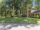 Two-story house with beautiful green lawn and large trees surrounding the property at 5617 Partridge Ln, Raleigh, NC 27609