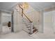 Grand foyer featuring a staircase, chandelier, and entrances to other rooms at 5617 Partridge Ln, Raleigh, NC 27609