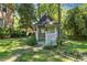 A white gazebo sits in a lush backyard at 5617 Partridge Ln, Raleigh, NC 27609
