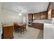 A well-lit kitchen showcases wood cabinets, white appliances, and tile floors at 5617 Partridge Ln, Raleigh, NC 27609