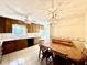 Traditional eat-in kitchen features tile flooring, a ceiling fan, wood cabinets, and dining table set at 5617 Partridge Ln, Raleigh, NC 27609