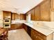 Traditional kitchen with wood cabinets, white countertops, and vintage appliances at 5617 Partridge Ln, Raleigh, NC 27609