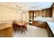 Traditional kitchen features tile flooring, a ceiling fan, wood cabinets, and dining table set at 5617 Partridge Ln, Raleigh, NC 27609