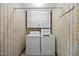 The laundry room includes overhead cabinets and a side-by-side washer and dryer at 5617 Partridge Ln, Raleigh, NC 27609