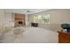 Spacious living room with a brick fireplace, built-in shelves, and plenty of natural light at 5617 Partridge Ln, Raleigh, NC 27609