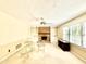 Spacious living room includes a fireplace, built-in shelving, and large windows at 5617 Partridge Ln, Raleigh, NC 27609
