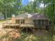 Back exterior view showcases deck and screened-in porch at 5709 Russell Rd, Durham, NC 27712