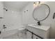 Well-lit bathroom offers tub/shower, modern vanity and matte black hardware at 5709 Russell Rd, Durham, NC 27712