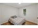 Cozy bedroom with wood floors and natural light from window at 5709 Russell Rd, Durham, NC 27712