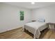 Clean bedroom with wood floors and sun-filled window views at 5709 Russell Rd, Durham, NC 27712
