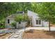 Lovely exterior view of a cozy home surrounded by lush greenery and a gravel walkway at 5709 Russell Rd, Durham, NC 27712