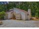Charming exterior view of modern home with a wooden deck and a gravel driveway at 5709 Russell Rd, Durham, NC 27712
