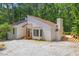 Charming exterior view of modern home with a wooden deck and a gravel driveway at 5709 Russell Rd, Durham, NC 27712