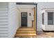 Inviting entryway featuring a stylish front door, a covered porch, and a well-lit exterior at 5709 Russell Rd, Durham, NC 27712