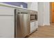 Kitchen with new stainless steel dishwasher and microwave, next to barn door at 5709 Russell Rd, Durham, NC 27712