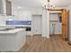 Bright kitchen boasts white cabinets, stainless steel appliances, modern lighting, and a convenient barn door at 5709 Russell Rd, Durham, NC 27712