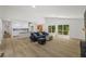 Spacious living area with luxury vinyl floors, natural light, and a view of the kitchen at 5709 Russell Rd, Durham, NC 27712
