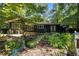Home exterior featuring a backyard with mature trees and lush landscaping providing privacy and a nature view at 5836 Sandstone Dr, Durham, NC 27713